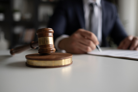 Judge or Legal advisor lawyer examining and signing legal documents.