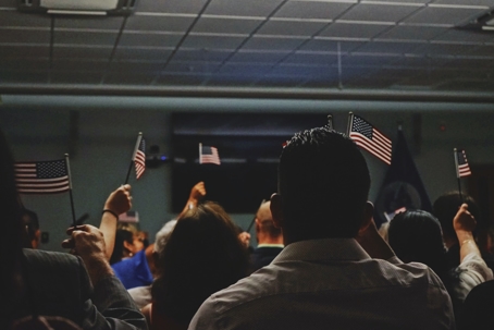 People in immigration office holding American flags
